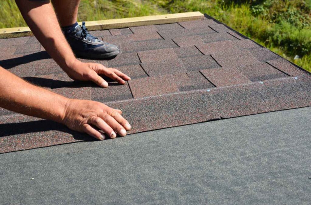 a Beantown employee fixing asphalt shingles roof