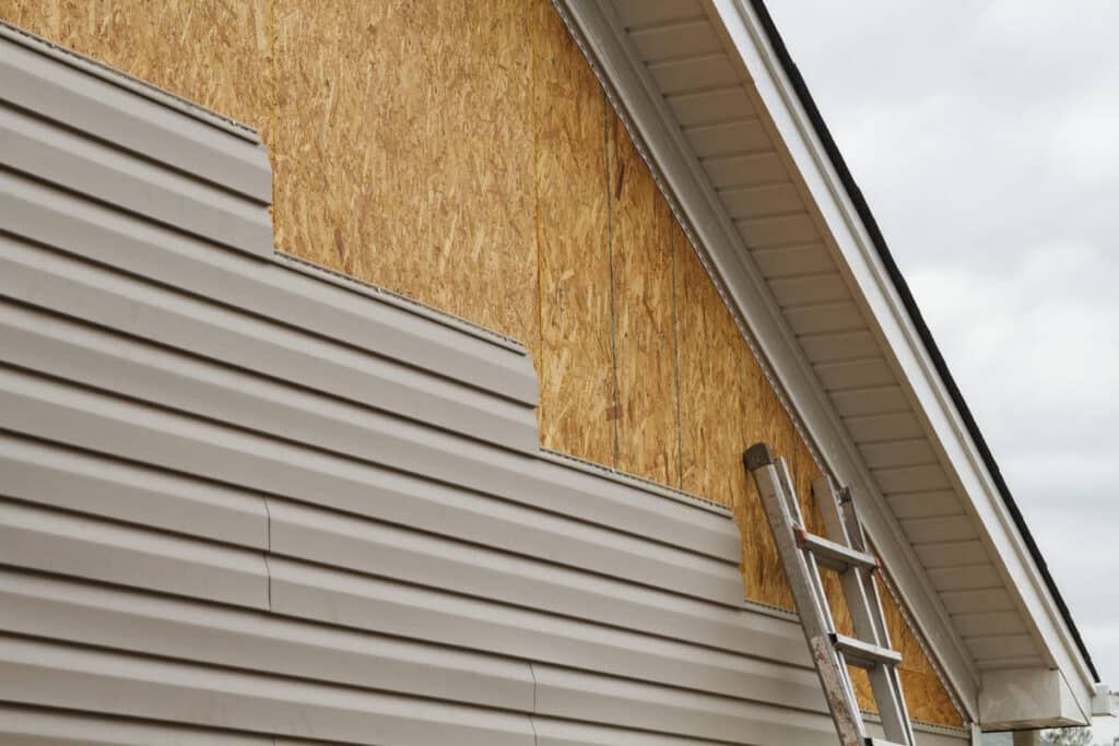 - A residential home mid-project with professional new siding installation in progress.